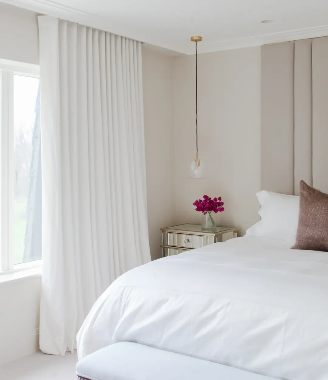Ready-made wave curtains hanging in a bedroom window